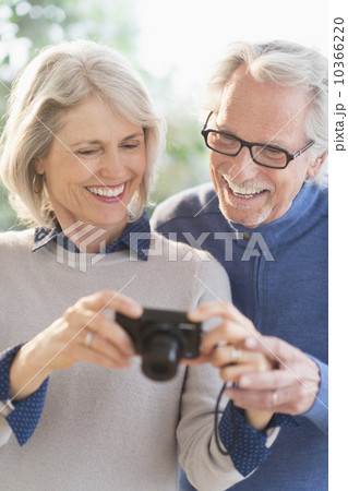 Smiling senior couple with digital camera 10366220