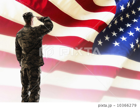 Army soldier saluting in front of American flag 10366279