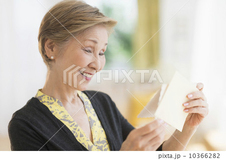 Senior woman reading note Senior woman reading note 10366282