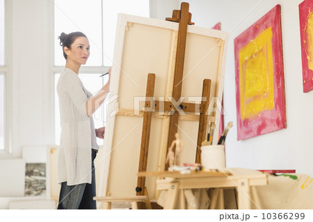 Woman painting at easel 10366299