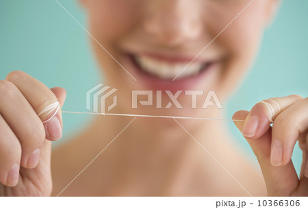 Close-up of woman holding dental floss Close-up of woman holding dental floss 10366306