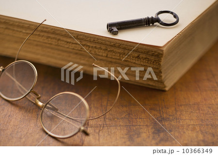 Antique book with key and eyeglasses 10366349