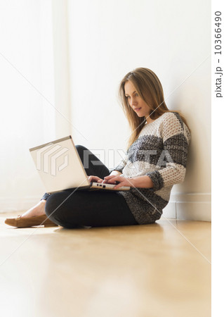 Portrait of young woman using laptop 10366490