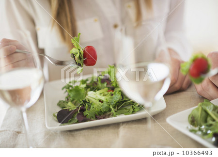 Midsection of woman eating salad 10366493