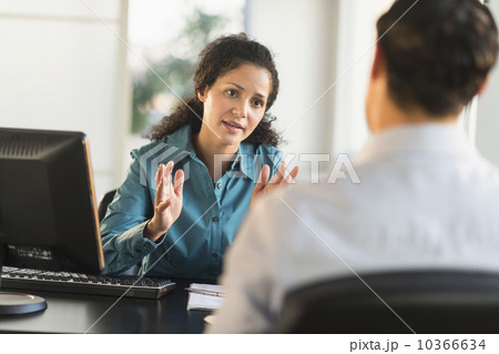 Woman interviewing man at desk Woman interviewing man at desk 10366634