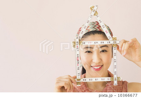 Woman holding tape measure  10366677