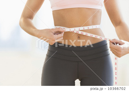 Woman measuring waist Woman measuring waist 10366702