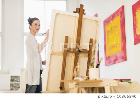 Woman painting at easel 10366840