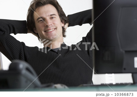 Smiling man at desk with computer 10366873