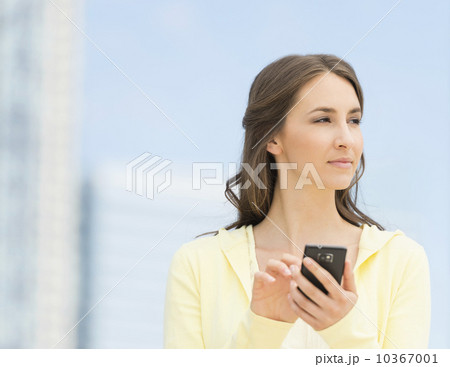 Young woman photographing herself with mobile phone Young woman photographing herself with mobile phone 10367001