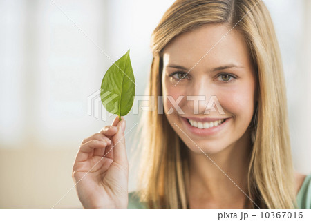Portrait of woman holding leaf 10367016