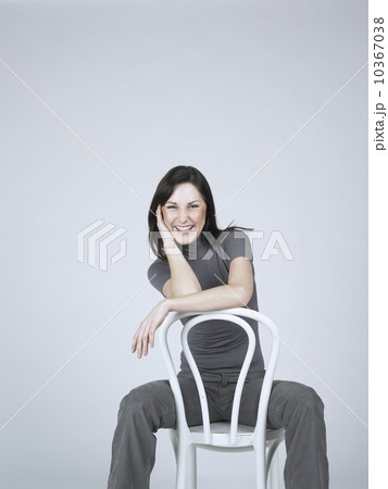 Smiling woman sitting on a chair 10367038