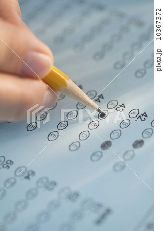 Close-up of hand filling out test 10367372