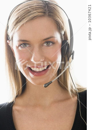 Studio portrait of young woman wearing headset Studio portrait of young woman wearing headset 10367421