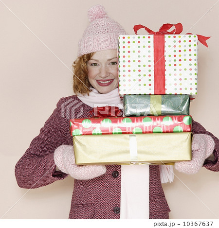 Woman holding stack of presents 10367637