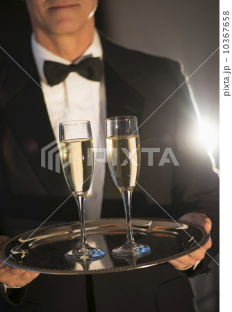 Waiter holding tray with champagne 10367658