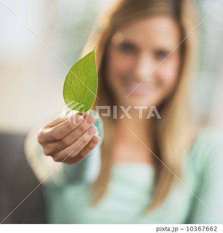 Woman holding leaf, focus on foreground Woman holding leaf, focus on foreground 10367662