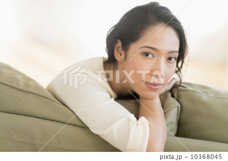 Portrait of young woman sitting on couch 10368045