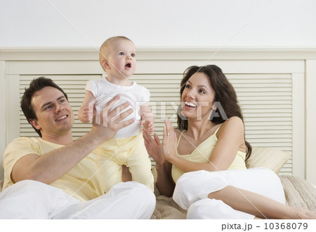 Proud couple lying down with infant 10368079