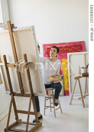 Female artist painting in her studio 10368083