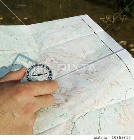 Hand holding a compass and map Hand holding a compass and map 10368310