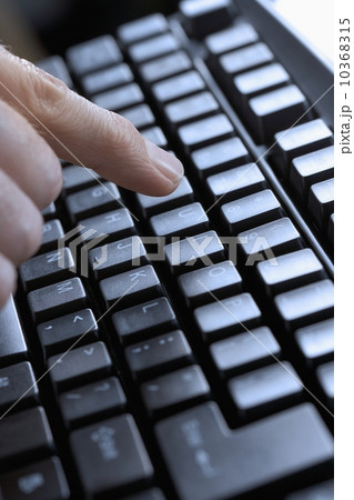 Closeup of finger and computer keyboard 10368315