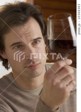 Closeup of man examining red wine Closeup of man examining red wine 10368363