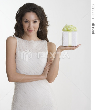Woman in formal dress holding gift 10368429
