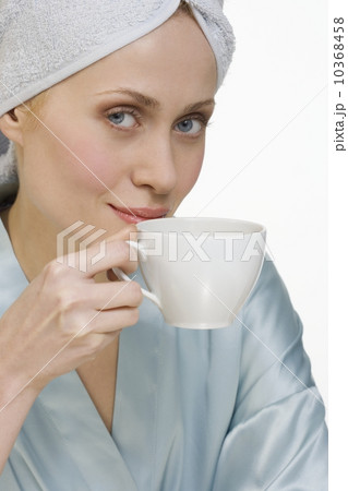 Woman in bathrobe with coffee cup 10368458
