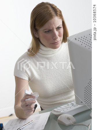 Distressed woman at desk with computer 10368574