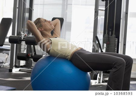 Woman using exercise ball 10368593