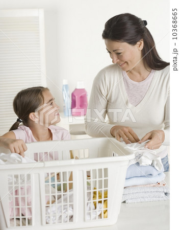 Mother and daughter doing laundry Mother and daughter doing laundry 10368665