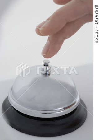 Closeup of finger ringing desk bell 10368688