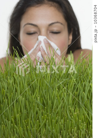 Woman blowing nose with grass Woman blowing nose with grass 10368704