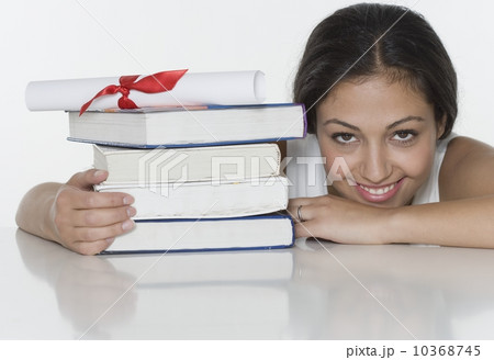 Woman with textbooks and diploma 10368745