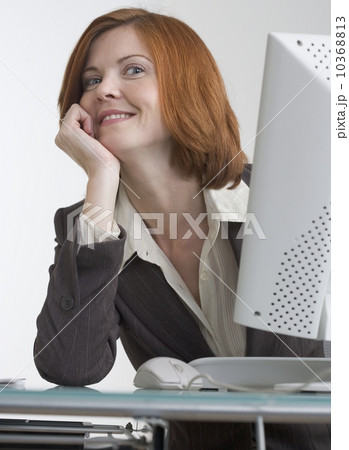 Smiling business woman with computer 10368813