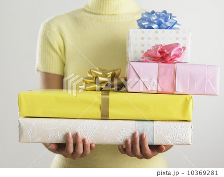 Woman holding pile of presents 10369281