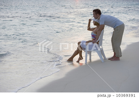 Couple relaxing at the beach Couple relaxing at the beach 10369391