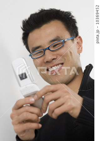 Young man using a mobile phone Young man using a mobile phone 10369452