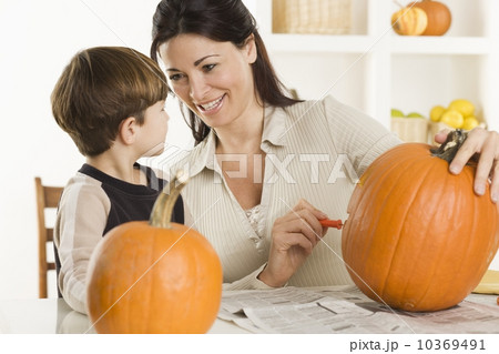 Mother and son carving pumpkins 10369491
