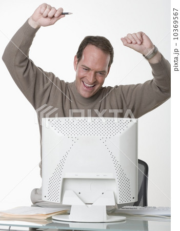Exuberant man at his computer 10369567