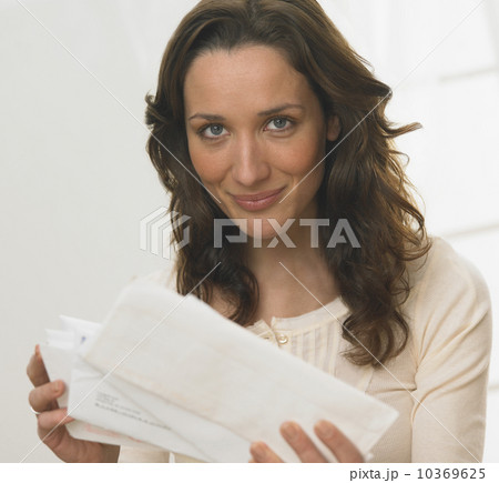 Portrait of woman holding mail 10369625