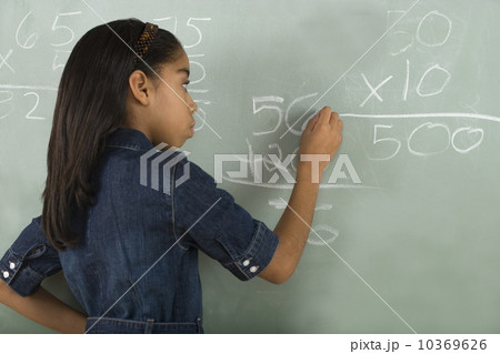 Girl writing on chalkboard Girl writing on chalkboard 10369626