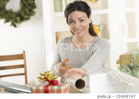 Woman wrapping Christmas gifts 10369747