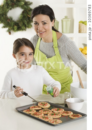 Mother and daughter baking Christmas cookies Mother and daughter baking Christmas cookies 10369783