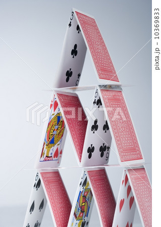 Playing cards stacked into a pyramid 10369833