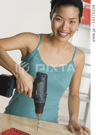 Portrait of woman doing home repairs Portrait of woman doing home repairs 10370208