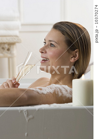 Woman in bathtub drinking champagne Woman in bathtub drinking champagne 10370274