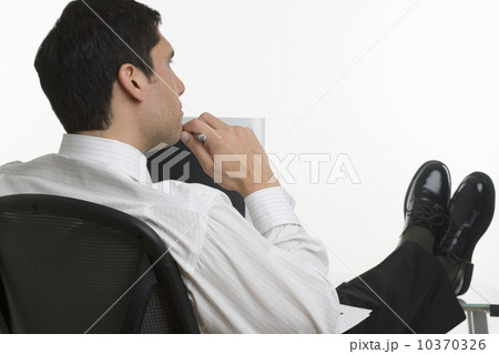 Businessman thinking with feet up 10370326