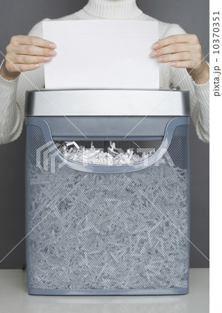 Woman using a paper shredder 10370351